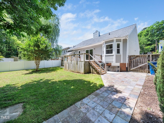 8312 Bellingham Cir, Raleigh, NC 27615 - back of house with a gate, a chimney, a patio, brick siding, and a deck
