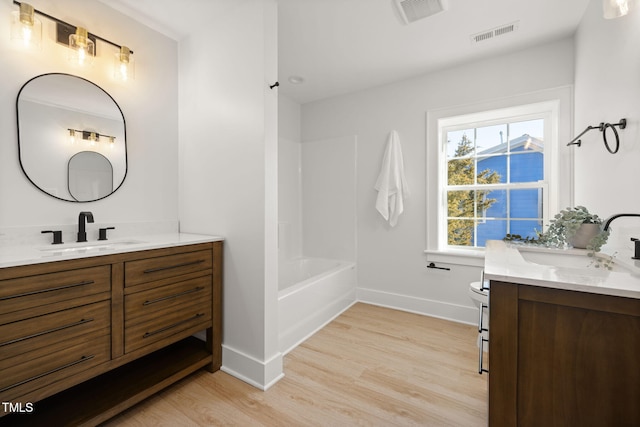 18 W Academy St, Wendell, NC 27591 - full bathroom with vanity, baseboards, wood finished floors, toilet, and shower / bathtub combination