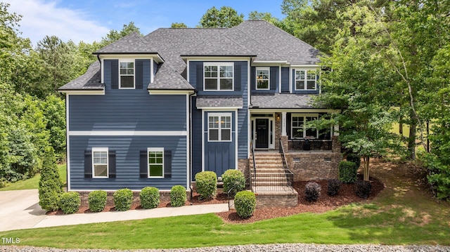 8304 Southmoor Hill Trl, Wake Forest, NC 27587 - view of front facade with a front lawn, roof with shingles, covered porch, and stairway