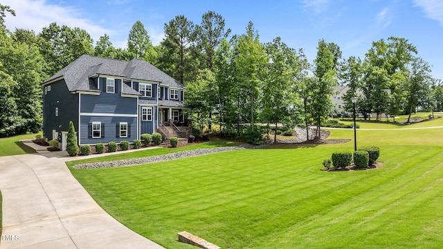 8304 Southmoor Hill Trl, Wake Forest, NC 27587 - view of front of home with a front yard, driveway, and view of wooded area