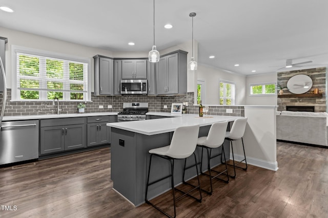 8304 Southmoor Hill Trl, Wake Forest, NC 27587 - kitchen featuring gray cabinets, stainless steel appliances, a sink, open floor plan, and recessed lighting