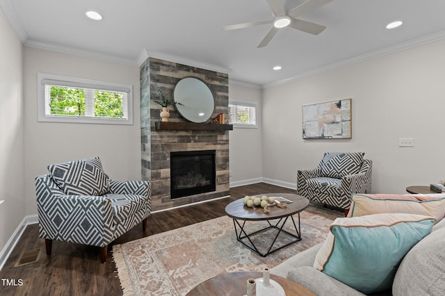 8304 Southmoor Hill Trl, Wake Forest, NC 27587 - living area featuring wood finished floors, baseboards, a tiled fireplace, a ceiling fan, and crown molding