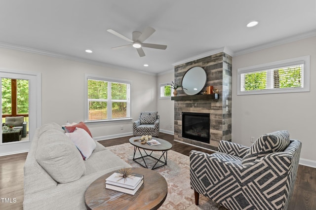 8304 Southmoor Hill Trl, Wake Forest, NC 27587 - living room with crown molding, a tiled fireplace, dark wood-style floors, a ceiling fan, and baseboards