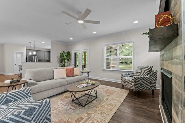 8304 Southmoor Hill Trl, Wake Forest, NC 27587 - living area featuring crown molding, baseboards, a ceiling fan, a tile fireplace, and dark wood finished floors