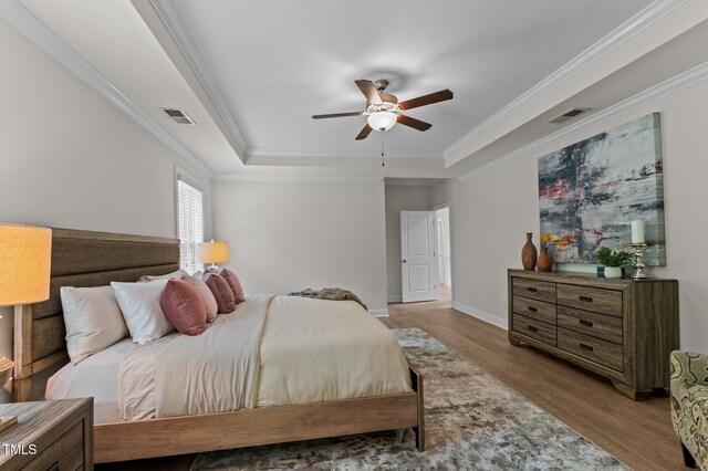 8304 Southmoor Hill Trl, Wake Forest, NC 27587 - bedroom with a tray ceiling, wood finished floors, ornamental molding, baseboards, and a ceiling fan