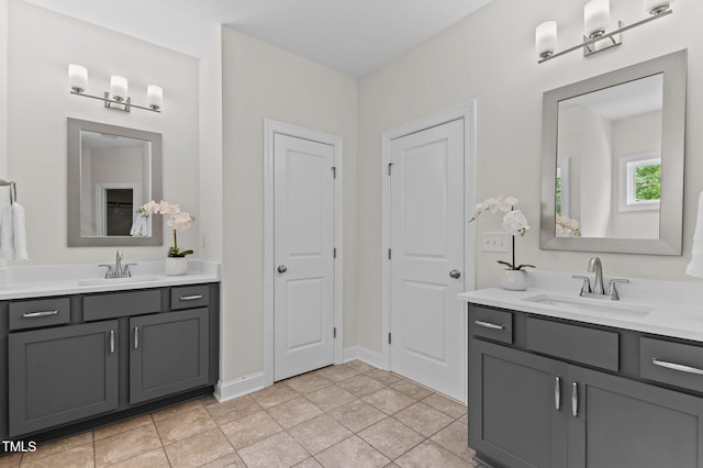8304 Southmoor Hill Trl, Wake Forest, NC 27587 - bathroom with two vanities and baseboards