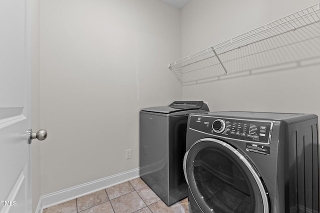 8304 Southmoor Hill Trl, Wake Forest, NC 27587 - laundry area with washer and dryer, baseboards, and light tile patterned floors