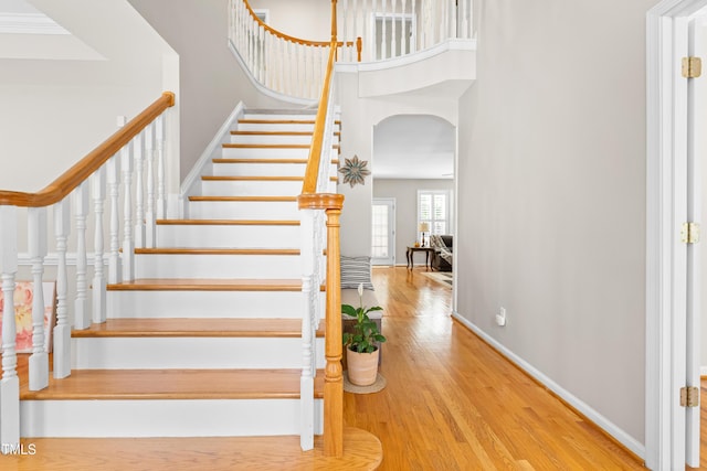 203 Worsham Dr, Chapel Hill, NC 27516 - staircase featuring wood finished floors, a high ceiling, baseboards, and arched walkways