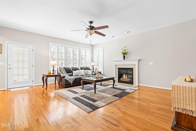 203 Worsham Dr, Chapel Hill, NC 27516 - living area with light wood-style floors, ceiling fan, a glass covered fireplace, and baseboards