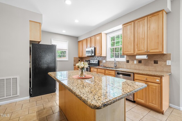 203 Worsham Dr, Chapel Hill, NC 27516 - kitchen featuring appliances with stainless steel finishes, a sink, light brown cabinets, decorative backsplash, and baseboards
