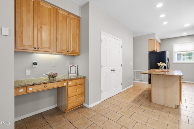 203 Worsham Dr, Chapel Hill, NC 27516 - kitchen with recessed lighting, light stone counters, baseboards, freestanding refrigerator, and light tile patterned floors
