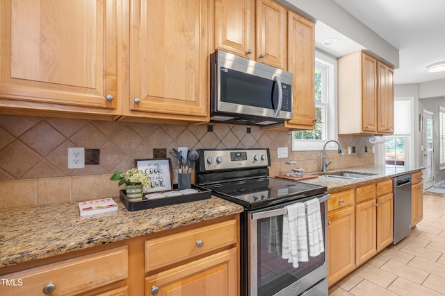 203 Worsham Dr, Chapel Hill, NC 27516 - kitchen featuring appliances with stainless steel finishes, a sink, light stone countertops, light tile patterned floors, and tasteful backsplash