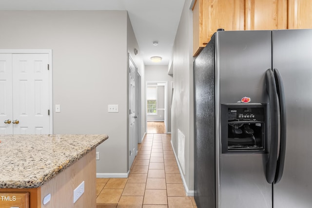 203 Worsham Dr, Chapel Hill, NC 27516 - kitchen featuring stainless steel refrigerator with ice dispenser, light tile patterned flooring, baseboards, light stone counters, and light brown cabinetry