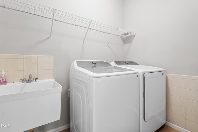 203 Worsham Dr, Chapel Hill, NC 27516 - laundry area featuring independent washer and dryer, tile walls, and wainscoting
