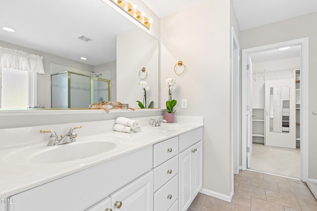 203 Worsham Dr, Chapel Hill, NC 27516 - bathroom with double vanity, tile patterned floors, a stall shower, a walk in closet, and recessed lighting