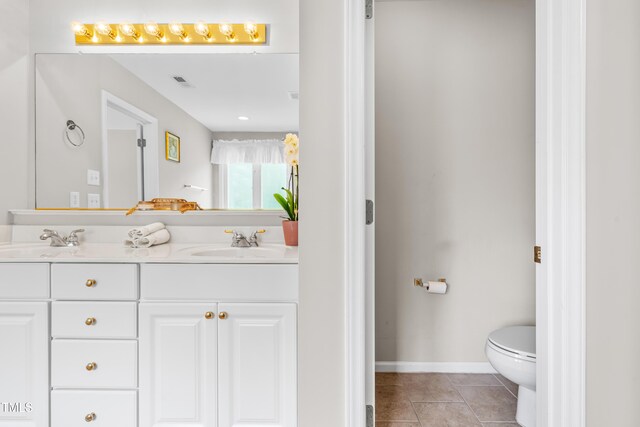 203 Worsham Dr, Chapel Hill, NC 27516 - bathroom with double vanity, toilet, baseboards, and tile patterned flooring