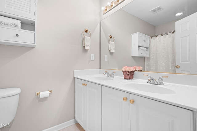 203 Worsham Dr, Chapel Hill, NC 27516 - bathroom with double vanity, toilet, and baseboards