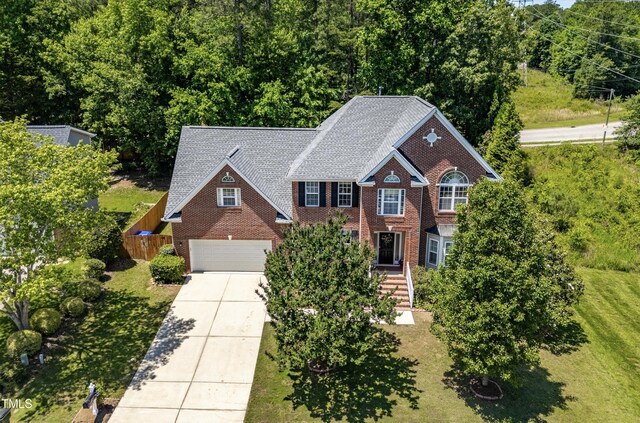 203 Worsham Dr, Chapel Hill, NC 27516 - view of front facade featuring concrete driveway, brick siding, a garage, and roof with shingles