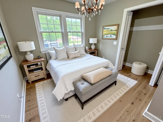 3804 Cobb St, Garner, NC 27529 - bedroom with a chandelier, light wood-style floors, and baseboards