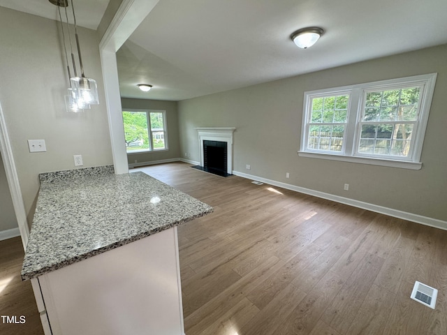 3804 Cobb St, Garner, NC 27529 - unfurnished living room featuring wood finished floors, baseboards, and a fireplace