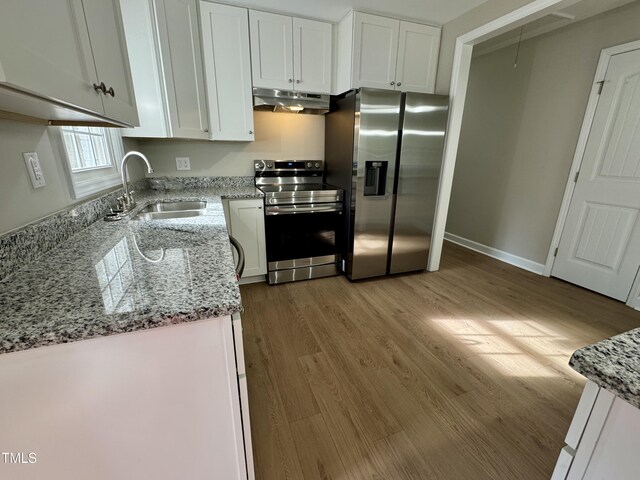 3804 Cobb St, Garner, NC 27529 - kitchen with stainless steel appliances, a sink, under cabinet range hood, and white cabinetry