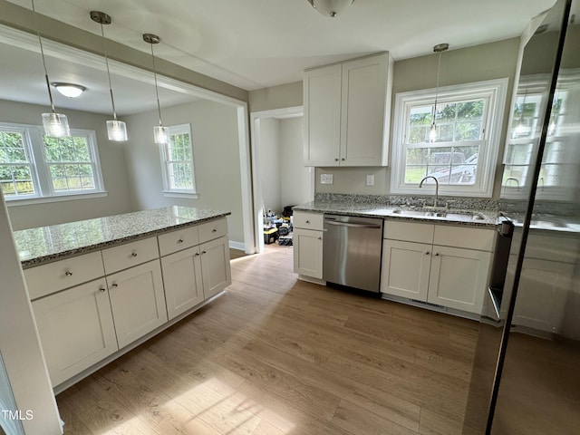 3804 Cobb St, Garner, NC 27529 - kitchen with stainless steel dishwasher, a sink, light wood-style floors, and light stone counters