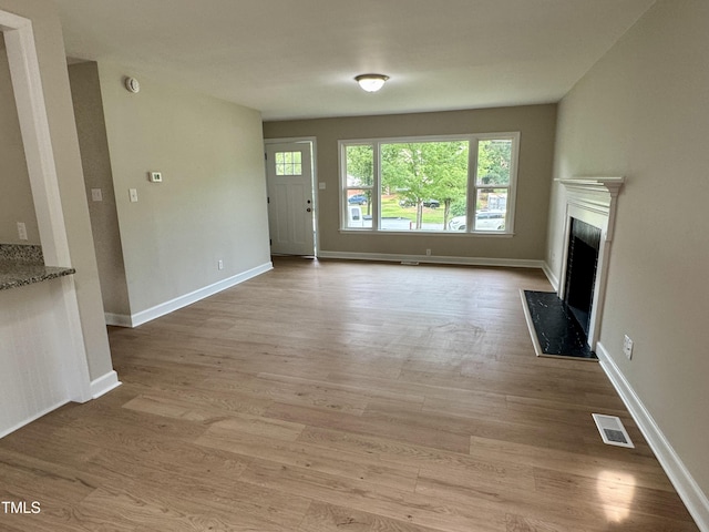 3804 Cobb St, Garner, NC 27529 - unfurnished living room featuring a fireplace, light wood finished floors, and baseboards