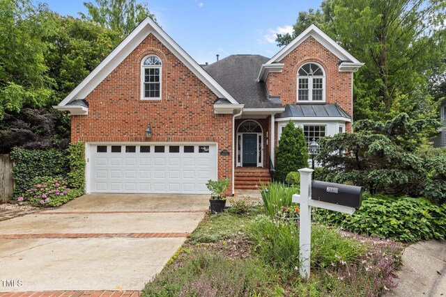 2001 Dobson Ct, Raleigh, NC 27612 - traditional-style home featuring brick siding, concrete driveway, and a shingled roof