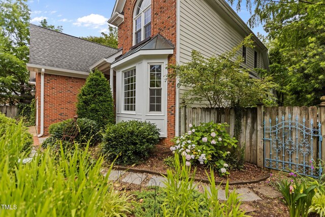 2001 Dobson Ct, Raleigh, NC 27612 - view of side of home featuring brick siding and a shingled roof