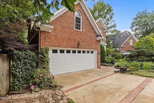 2001 Dobson Ct, Raleigh, NC 27612 - view of property exterior featuring brick siding, driveway, and an attached garage