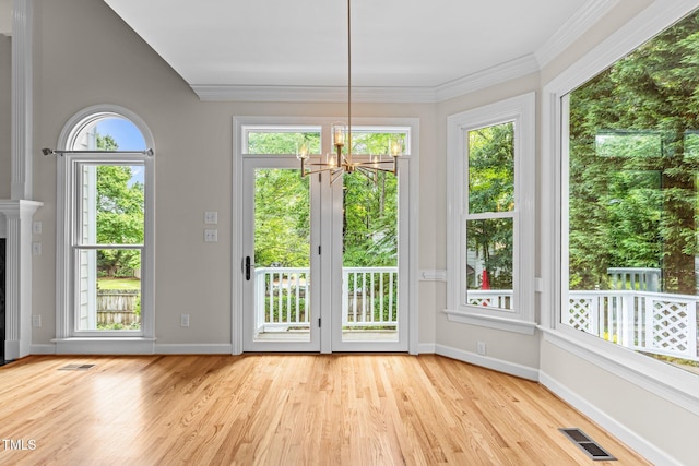 2001 Dobson Ct, Raleigh, NC 27612 - doorway with a chandelier, wood finished floors, baseboards, and ornamental molding