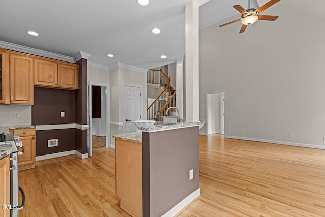 2001 Dobson Ct, Raleigh, NC 27612 - kitchen with stainless steel range oven, ceiling fan, light wood-type flooring, ornamental molding, and light stone countertops