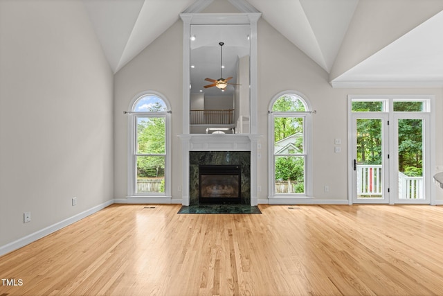 2001 Dobson Ct, Raleigh, NC 27612 - unfurnished living room with wood finished floors, healthy amount of natural light, a premium fireplace, high vaulted ceiling, and baseboards