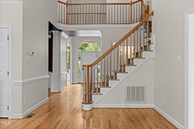 2001 Dobson Ct, Raleigh, NC 27612 - entryway featuring wood finished floors, baseboards, stairway, and a towering ceiling