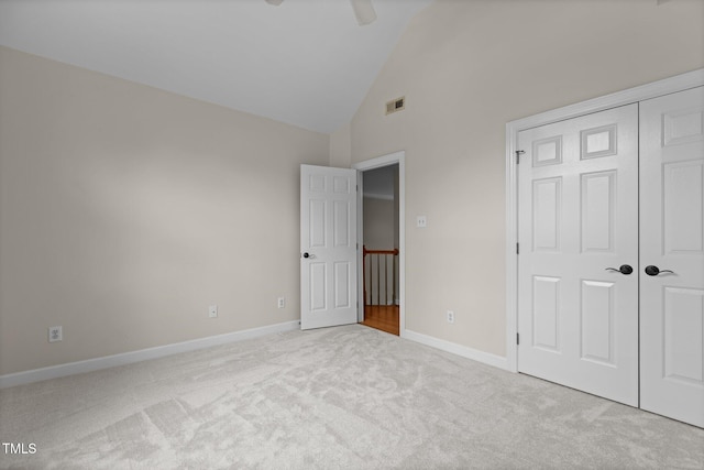 2001 Dobson Ct, Raleigh, NC 27612 - unfurnished bedroom featuring carpet, a closet, baseboards, and high vaulted ceiling