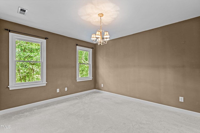 2001 Dobson Ct, Raleigh, NC 27612 - carpeted empty room featuring a chandelier, healthy amount of natural light, and baseboards