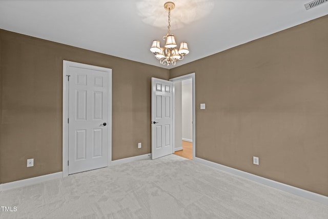 2001 Dobson Ct, Raleigh, NC 27612 - carpeted empty room with a chandelier and baseboards