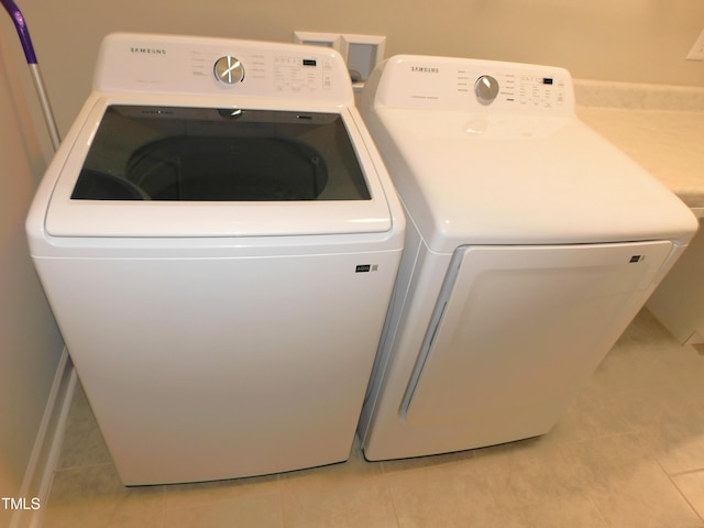 1311 Arena Ln, Fuquay Varina, NC 27526 - laundry area featuring washer and clothes dryer and light tile patterned floors