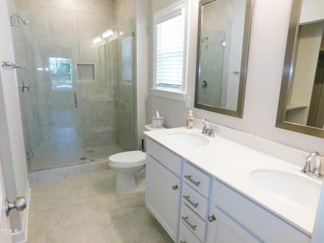 1311 Arena Ln, Fuquay Varina, NC 27526 - full bath with a shower stall, double vanity, toilet, and tile patterned flooring