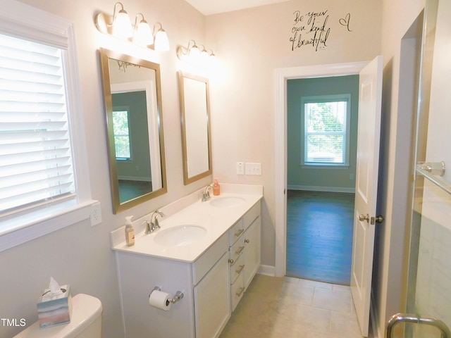 1311 Arena Ln, Fuquay Varina, NC 27526 - bathroom featuring double vanity, toilet, tile patterned flooring, and baseboards