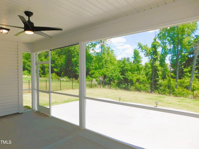 1311 Arena Ln, Fuquay Varina, NC 27526 - unfurnished sunroom featuring a ceiling fan and view of wooded area