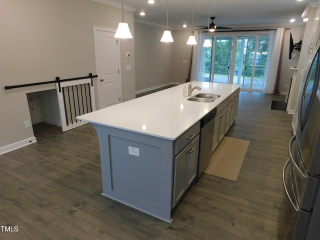 1311 Arena Ln, Fuquay Varina, NC 27526 - kitchen with stainless steel appliances, gray cabinetry, a sink, light countertops, and an island with sink