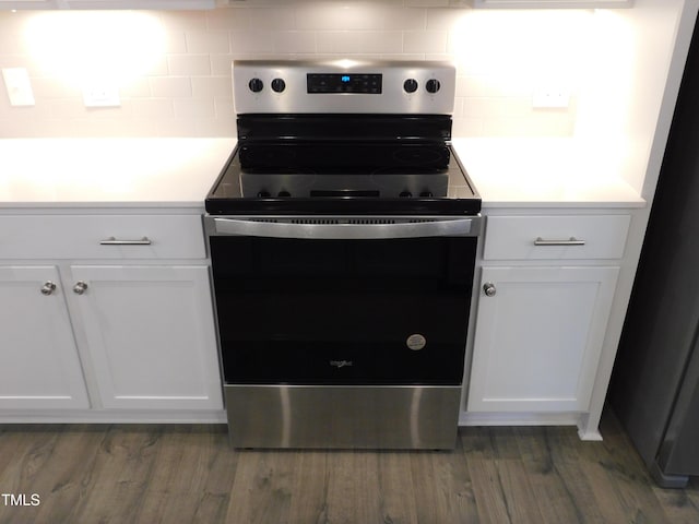 1311 Arena Ln, Fuquay Varina, NC 27526 - kitchen featuring stainless steel range with electric stovetop, decorative backsplash, white cabinets, and light countertops