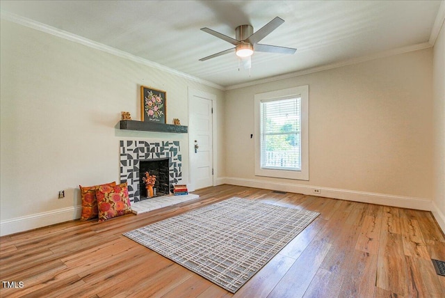 5625 Church Rd, Graham, NC 27253 - living area featuring baseboards, hardwood / wood-style flooring, a stone fireplace, and crown molding