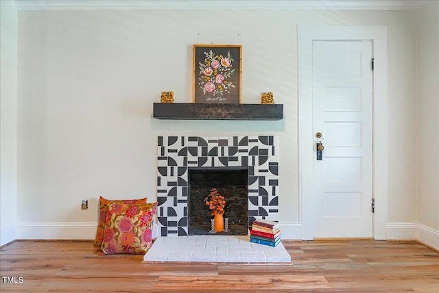 5625 Church Rd, Graham, NC 27253 - detailed view of wood finished floors, baseboards, crown molding, and a fireplace