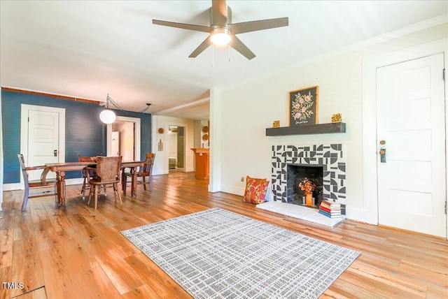 5625 Church Rd, Graham, NC 27253 - living room with light wood-style flooring, ornamental molding, ceiling fan, a stone fireplace, and baseboards