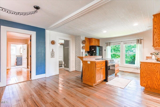 5625 Church Rd, Graham, NC 27253 - kitchen featuring electric stove, light countertops, freestanding refrigerator, light wood-style floors, and wooden ceiling