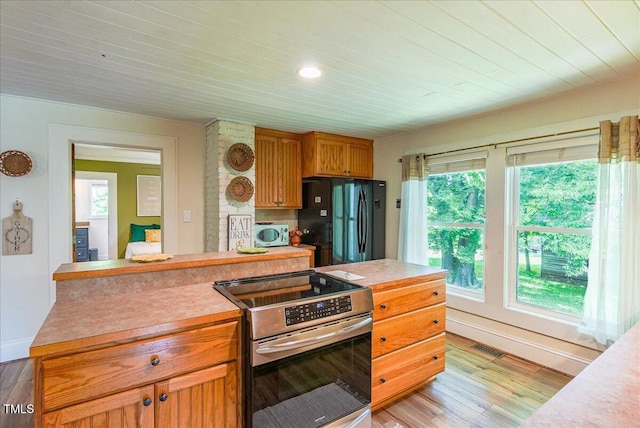 5625 Church Rd, Graham, NC 27253 - kitchen with electric range, freestanding refrigerator, light countertops, light wood-type flooring, and wood ceiling