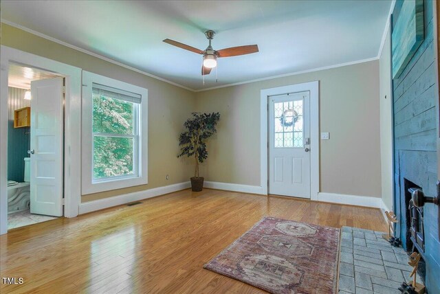 5625 Church Rd, Graham, NC 27253 - foyer entrance featuring healthy amount of natural light, crown molding, a ceiling fan, baseboards, and wood finished floors