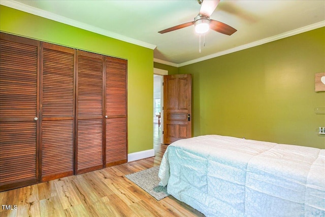 5625 Church Rd, Graham, NC 27253 - bedroom with a closet, wood finished floors, baseboards, crown molding, and a ceiling fan